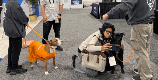 Attendee taking a pic with a therapy dog
